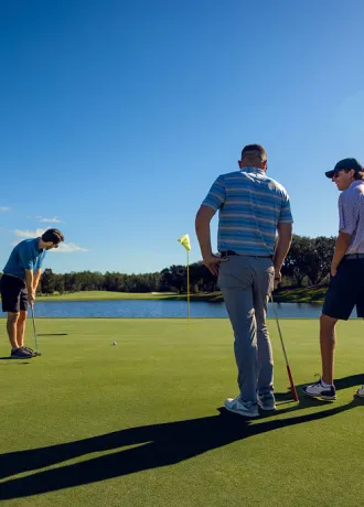 Golfers putting on Island Green Golfers putting on Island Green