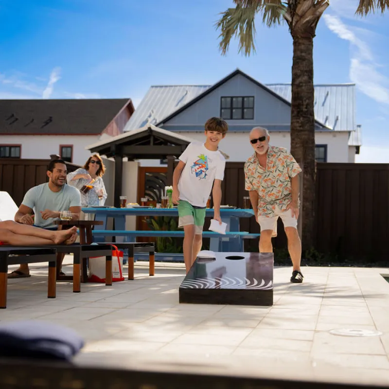 Backyard Cornhole family playing cornhole in the backyard