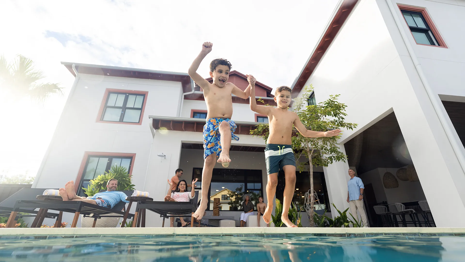 Kids Jumping into Private Heated Pool An image of two kids jumping into a private heated pool at a vacation rental house at Evermore Orlando Resort.