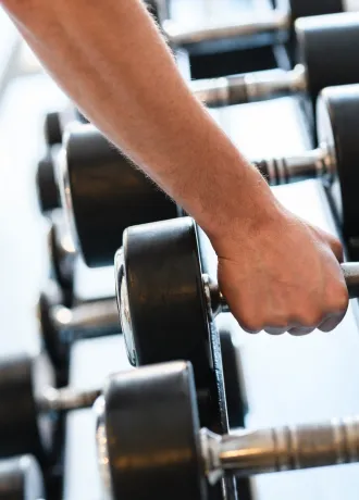 Weights in Gym Hand holding weights lined up in the gym