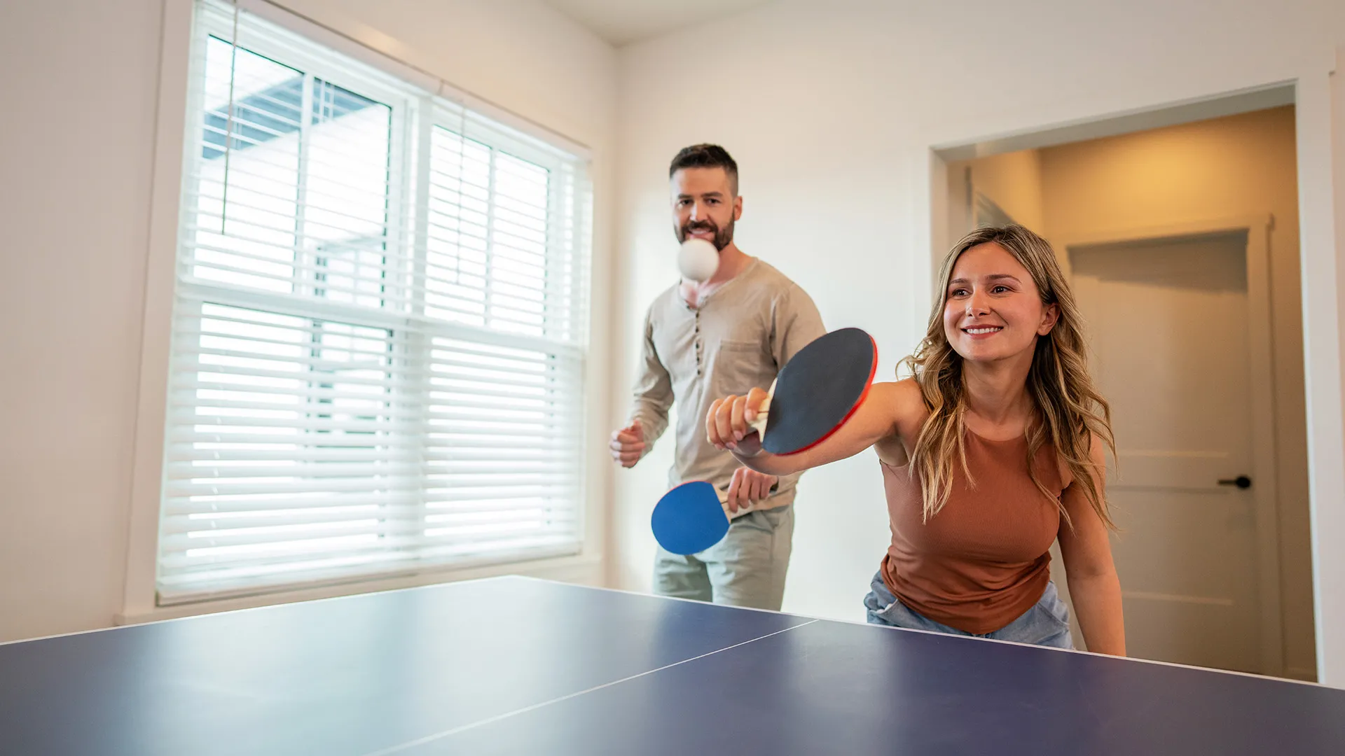 Table Tennis in an Evermore House An image of guests having fun while playing ping pong inside their vacation House at Evermore Orlando Resort.