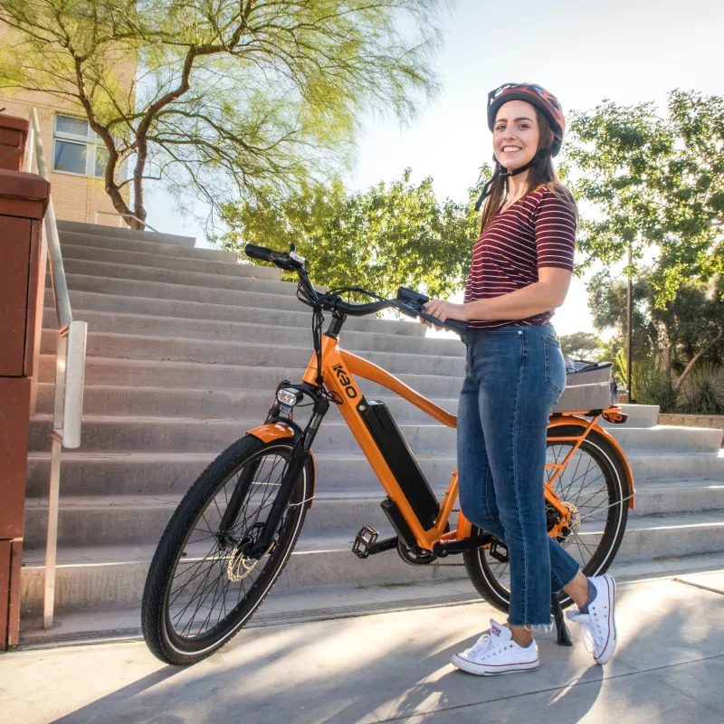 Guest Enjoying Bicycling guest standing beside bicycle wearing helmet and smiling