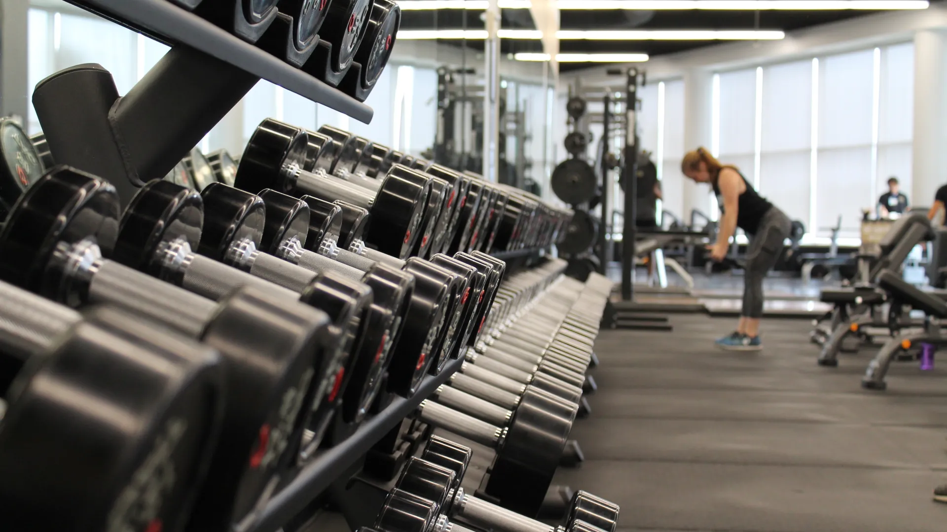 Gym Interior Gym Interior with close up of weights and guest working out in distance