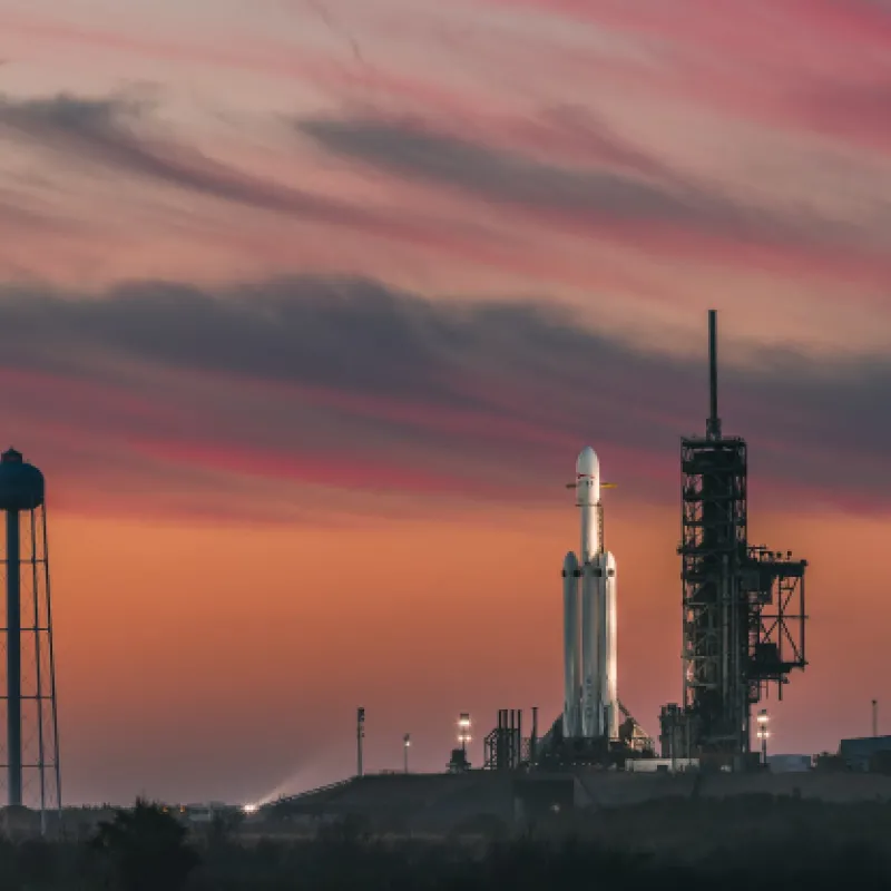 Kennedy Space Center Kennedy Space Center with rocket on launch pad during sunset