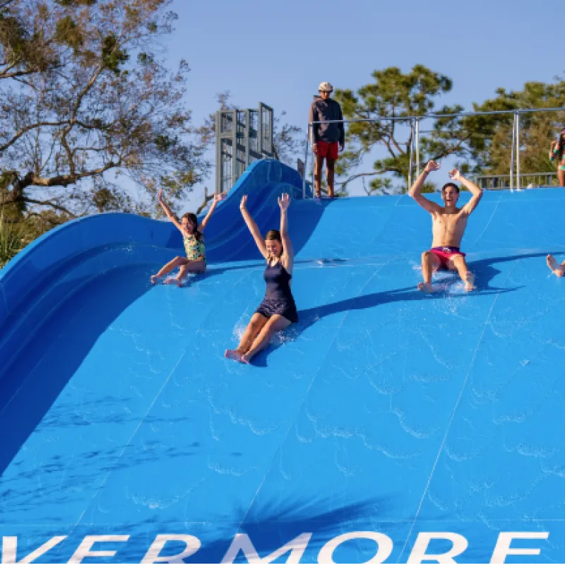 People enjoying the water slide People enjoying the water slide
