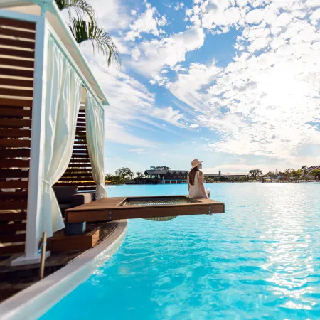 Image of a woman relaxing in an Overwater Cabana on Evermore Bay at Evermore Orlando Resort.