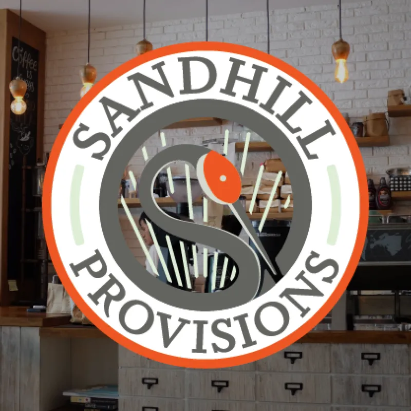 Sandhill Provisions Interior image of Sandhill Provisions cafe with Sandhill Provisions logo overlayed